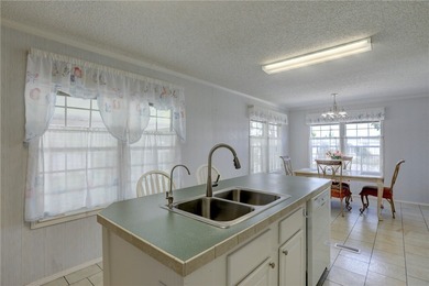 Fruit Trees, Sunshine & Freedom-it's all here on a fenced lot on Barefoot Bay Golf Course in Florida - for sale on GolfHomes.com, golf home, golf lot