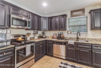 Located in the heart of Diamondhead, this 3-bedroom, 2-bath home on Diamondhead Country Club in Mississippi - for sale on GolfHomes.com, golf home, golf lot