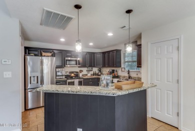 Located in the heart of Diamondhead, this 3-bedroom, 2-bath home on Diamondhead Country Club in Mississippi - for sale on GolfHomes.com, golf home, golf lot