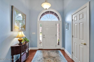 Enjoy serene pond views with this stunning brick home located in on Cape Fear National At Brunswick Forest in North Carolina - for sale on GolfHomes.com, golf home, golf lot