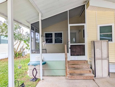 This unfurnished 2BR/1.5b park home is located on a quiet street on The Great Outdoors Golf and Country Club in Florida - for sale on GolfHomes.com, golf home, golf lot