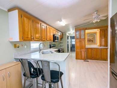 This unfurnished 2BR/1.5b park home is located on a quiet street on The Great Outdoors Golf and Country Club in Florida - for sale on GolfHomes.com, golf home, golf lot