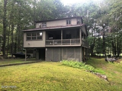 Bordering the 13th fairway, this Tanglwood Lakes homes offers 3 on Paupack Hills Golf and Country Club in Pennsylvania - for sale on GolfHomes.com, golf home, golf lot