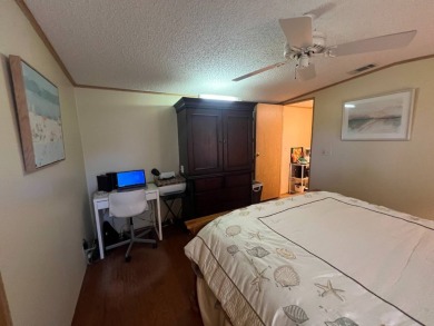 This 2/2 home will be offered fully furnished and it includes on Lake Henry Golf Club in Florida - for sale on GolfHomes.com, golf home, golf lot