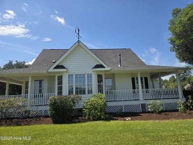 This charming farmhouse-style home with wraparound porches on Ocean Ridge Plantation in North Carolina - for sale on GolfHomes.com, golf home, golf lot