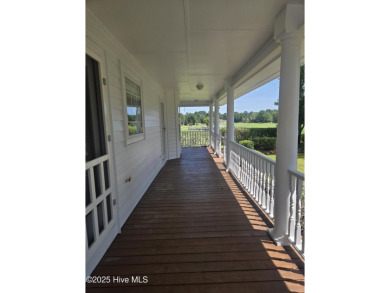 This charming farmhouse-style home with wraparound porches on Ocean Ridge Plantation in North Carolina - for sale on GolfHomes.com, golf home, golf lot