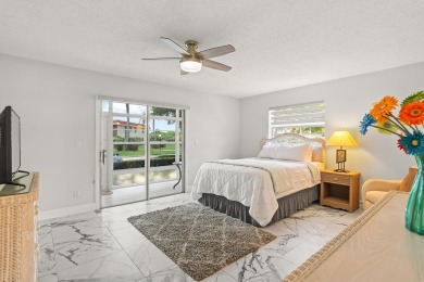 Charming, light-filled 1BR/1.5BA first-floor end unit nestled in on The American Golf Club in Florida - for sale on GolfHomes.com, golf home, golf lot