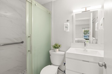 Charming, light-filled 1BR/1.5BA first-floor end unit nestled in on The American Golf Club in Florida - for sale on GolfHomes.com, golf home, golf lot