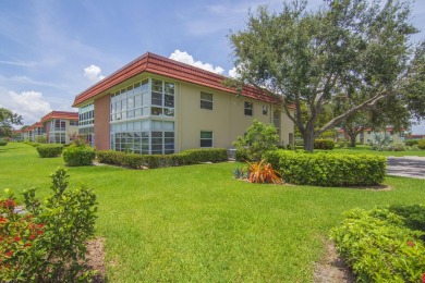 Charming, light-filled 1BR/1.5BA first-floor end unit nestled in on The American Golf Club in Florida - for sale on GolfHomes.com, golf home, golf lot