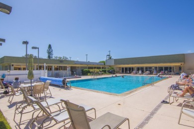 Charming, light-filled 1BR/1.5BA first-floor end unit nestled in on The American Golf Club in Florida - for sale on GolfHomes.com, golf home, golf lot