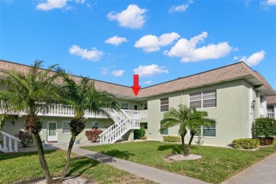 WELCOME TO THE GREEN DOLPHIN! This beautifully updated end-unit on Tarpon Springs Golf Course in Florida - for sale on GolfHomes.com, golf home, golf lot