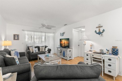 WELCOME TO THE GREEN DOLPHIN! This beautifully updated end-unit on Tarpon Springs Golf Course in Florida - for sale on GolfHomes.com, golf home, golf lot