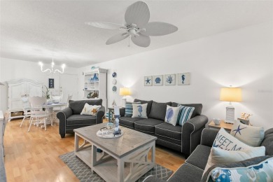 WELCOME TO THE GREEN DOLPHIN! This beautifully updated end-unit on Tarpon Springs Golf Course in Florida - for sale on GolfHomes.com, golf home, golf lot
