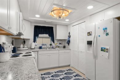 WELCOME TO THE GREEN DOLPHIN! This beautifully updated end-unit on Tarpon Springs Golf Course in Florida - for sale on GolfHomes.com, golf home, golf lot