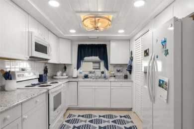 WELCOME TO THE GREEN DOLPHIN! This beautifully updated end-unit on Tarpon Springs Golf Course in Florida - for sale on GolfHomes.com, golf home, golf lot