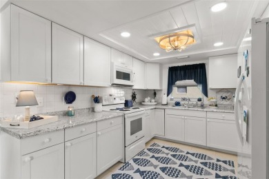 WELCOME TO THE GREEN DOLPHIN! This beautifully updated end-unit on Tarpon Springs Golf Course in Florida - for sale on GolfHomes.com, golf home, golf lot