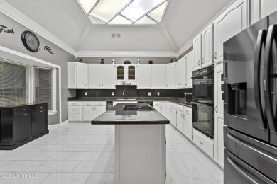 Enjoy timeless elegance and custom craftsmanship in this on Diamondhead Country Club in Mississippi - for sale on GolfHomes.com, golf home, golf lot