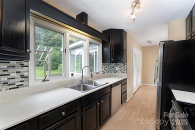 You must see this light-filled, two-story end unit condo at The on Black Mountain Golf Course in North Carolina - for sale on GolfHomes.com, golf home, golf lot