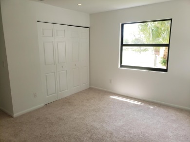 Newly painted, spacious corner unit 2/2 condo with water views on Village Golf Club in Florida - for sale on GolfHomes.com, golf home, golf lot