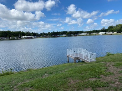 THIS TRIPLE WIDE LAKE FRONT HOME LOCATED IN THE ALL AGES SILVER on Silver Dollar Golf and Trap Club in Florida - for sale on GolfHomes.com, golf home, golf lot