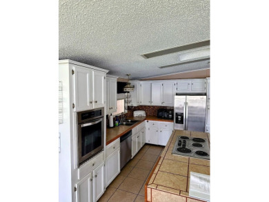 Welcome to Paradise! Paradise island is a 55+ active community on Fairway Village Golf Course in Florida - for sale on GolfHomes.com, golf home, golf lot