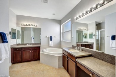 Enjoy sparkling lake and serene golf course views in this on Valencia Golf and Country Club in Florida - for sale on GolfHomes.com, golf home, golf lot