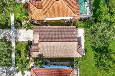 Enjoy sparkling lake and serene golf course views in this on Valencia Golf and Country Club in Florida - for sale on GolfHomes.com, golf home, golf lot