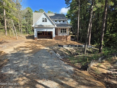 Discover refined living in this stunning new construction by on Seven Lakes Country Club in North Carolina - for sale on GolfHomes.com, golf home, golf lot