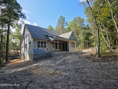 Discover refined living in this stunning new construction by on Seven Lakes Country Club in North Carolina - for sale on GolfHomes.com, golf home, golf lot