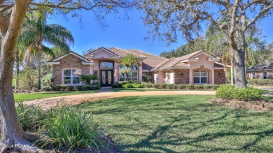 A beautifully landscaped circular driveway leads to this on Plantation Bay Golf and Country Club in Florida - for sale on GolfHomes.com, golf home, golf lot