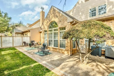 Perched on a beautiful tree-lined street in gated The Highlands on Oak Tree National Golf and Country Club in Oklahoma - for sale on GolfHomes.com, golf home, golf lot