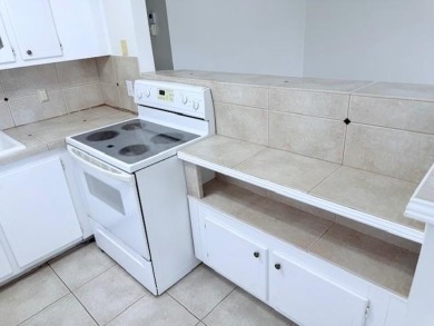 1st floor corner 2 bedroom,2 bath quiet Tilford location on Hillsboro Pines Golf in Florida - for sale on GolfHomes.com, golf home, golf lot