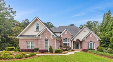 This exquisite four-sided blush brick estate is the epitome of on Royal Lakes Golf and Country Club in Georgia - for sale on GolfHomes.com, golf home, golf lot