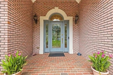 This exquisite four-sided blush brick estate is the epitome of on Royal Lakes Golf and Country Club in Georgia - for sale on GolfHomes.com, golf home, golf lot