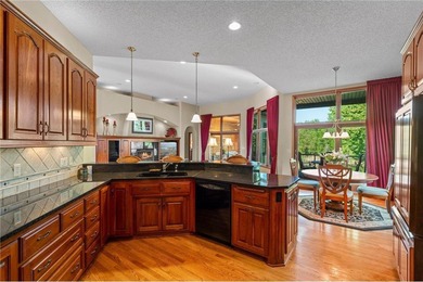 Experience the best of one-level living with peaceful lake views on TPC of the Twin Cities in Minnesota - for sale on GolfHomes.com, golf home, golf lot