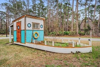 This wonderfully Eclectic Cottage is nestled next to dunes in on Isle Dauphine Club Golf Course in Alabama - for sale on GolfHomes.com, golf home, golf lot