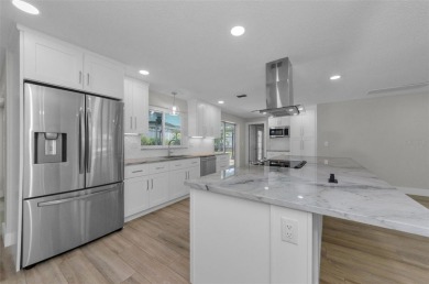 Welcome to this stunning renovated 4-bedroom, 3-bathroom pool on The Dunedin Country Club in Florida - for sale on GolfHomes.com, golf home, golf lot