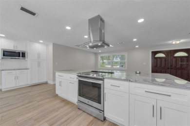 Welcome to this stunning renovated 4-bedroom, 3-bathroom pool on The Dunedin Country Club in Florida - for sale on GolfHomes.com, golf home, golf lot