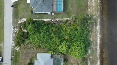 Location! Location! This is a .28 acre lot across the canal from on Mirror Lakes Golf Club in Florida - for sale on GolfHomes.com, golf home, golf lot