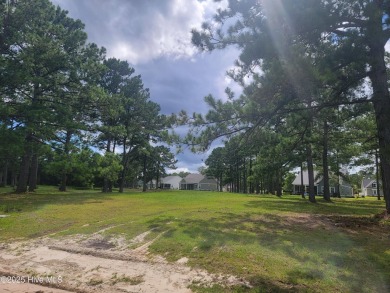 Pond-front home site ready for your dream home located in the on Sea Trail Golf Resort in North Carolina - for sale on GolfHomes.com, golf home, golf lot