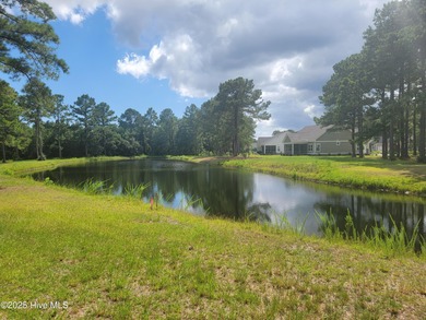 Pond-front home site ready for your dream home located in the on Sea Trail Golf Resort in North Carolina - for sale on GolfHomes.com, golf home, golf lot