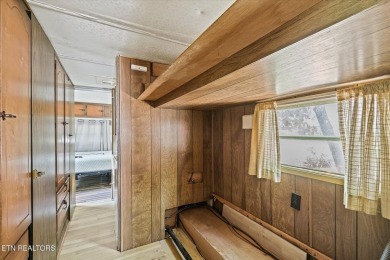 Take a look at this camper with a sunroom located in Holiday Out on Lake Tansi Village Country Club in Tennessee - for sale on GolfHomes.com, golf home, golf lot