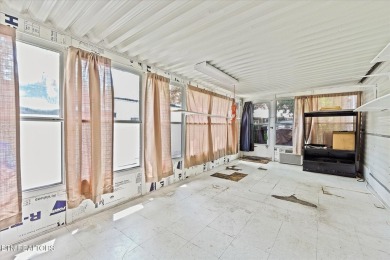 Take a look at this camper with a sunroom located in Holiday Out on Lake Tansi Village Country Club in Tennessee - for sale on GolfHomes.com, golf home, golf lot
