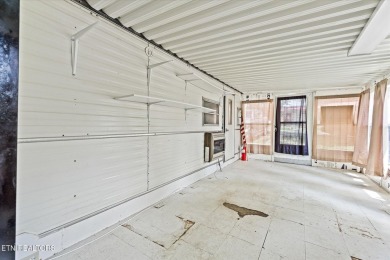Take a look at this camper with a sunroom located in Holiday Out on Lake Tansi Village Country Club in Tennessee - for sale on GolfHomes.com, golf home, golf lot