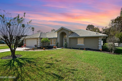 Nestled on a desirable corner lot overlooking a tranquil pond in on Spruce Creek Golf Club in Florida - for sale on GolfHomes.com, golf home, golf lot