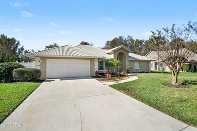 Nestled on a desirable corner lot overlooking a tranquil pond in on Spruce Creek Golf Club in Florida - for sale on GolfHomes.com, golf home, golf lot
