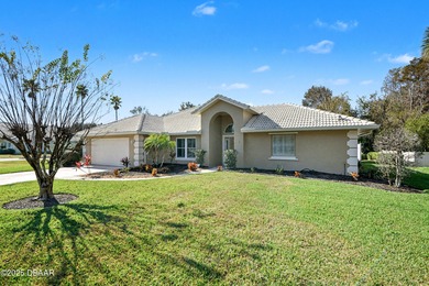 Nestled on a desirable corner lot overlooking a tranquil pond in on Spruce Creek Golf Club in Florida - for sale on GolfHomes.com, golf home, golf lot