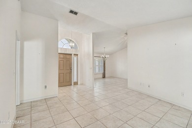 Nestled on a desirable corner lot overlooking a tranquil pond in on Spruce Creek Golf Club in Florida - for sale on GolfHomes.com, golf home, golf lot