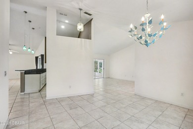 Nestled on a desirable corner lot overlooking a tranquil pond in on Spruce Creek Golf Club in Florida - for sale on GolfHomes.com, golf home, golf lot