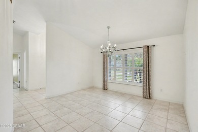 Nestled on a desirable corner lot overlooking a tranquil pond in on Spruce Creek Golf Club in Florida - for sale on GolfHomes.com, golf home, golf lot